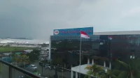Gedung kantor pusat PT Sri Rejeki Isman Tbk (Sritex) berpapan nama biru dengan bendera Merah Putih dan atap pabrik di kawasan industri Sukoharjo